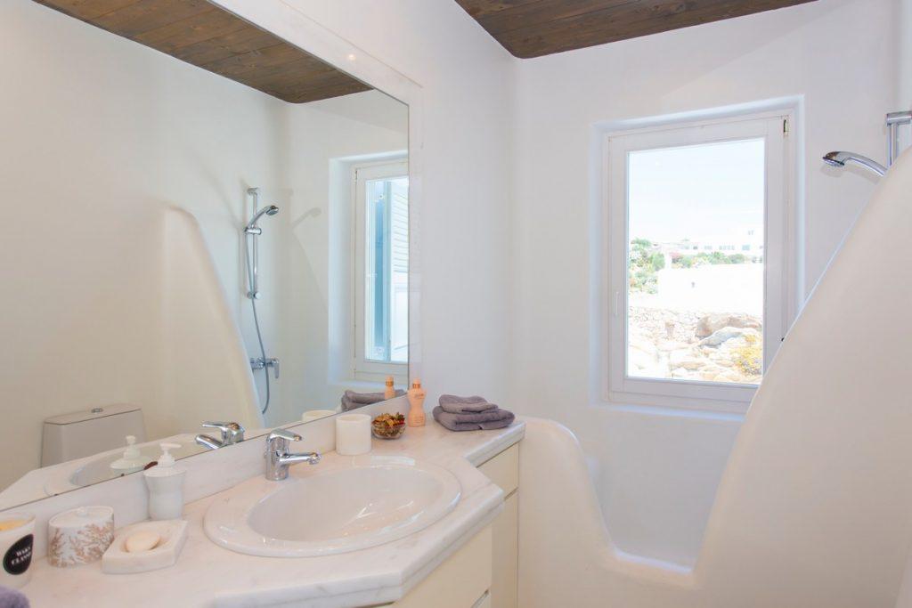 bathroom with large mirror and white sink
