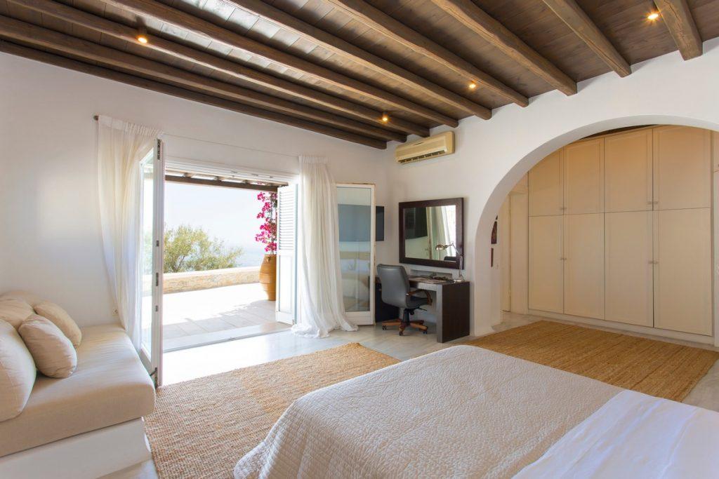 bedroom with large terrace door and sea view