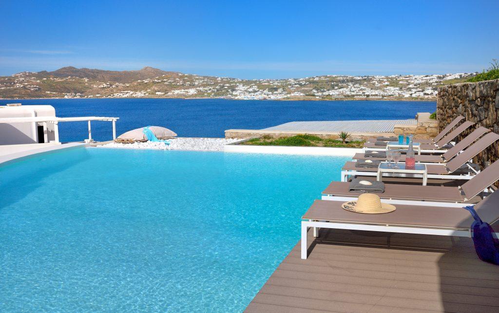 pool overlooking the crystal blue sea and bar