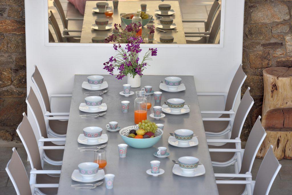 gray dining table with decorative bouquet of flowers ideal for a pleasant lunch with friends outdoors