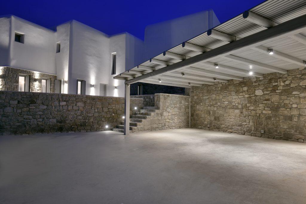 night view of a luxurious white villa with stone details