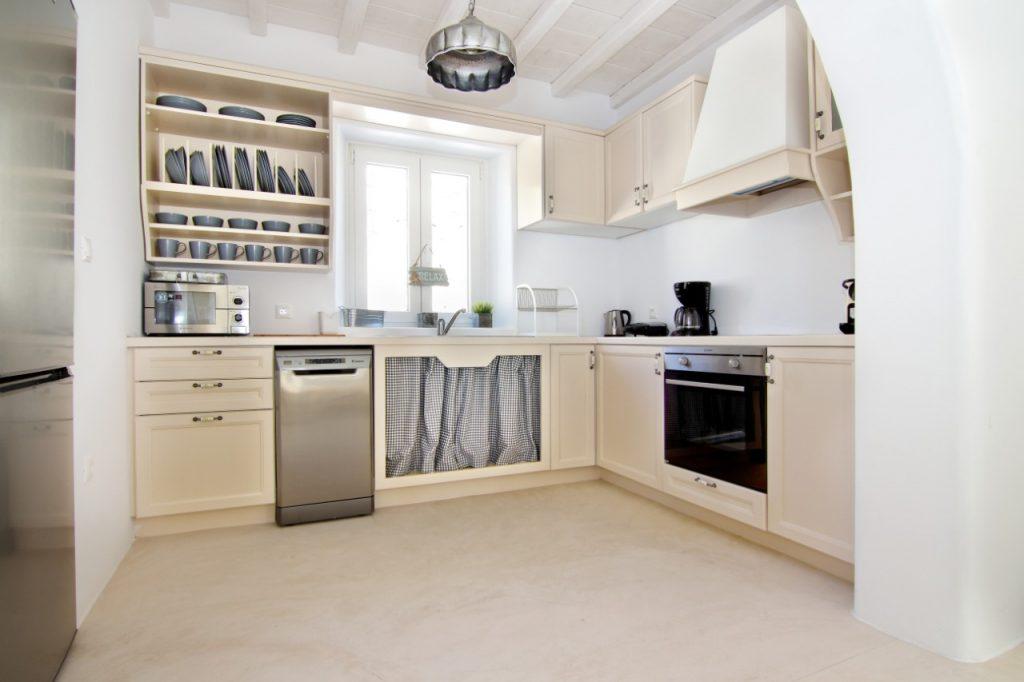 kitchen with white walls and wooden elements ideal for preparing delicious meals