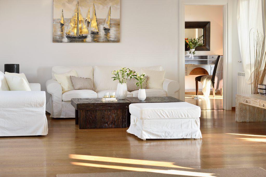 white walls of the living room with comfortable furniture and a special detail of the decorative painting