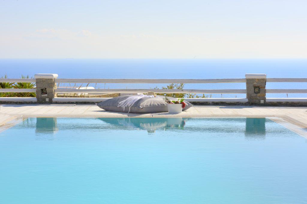 view of the crystal blue sea and clear sky from the pool