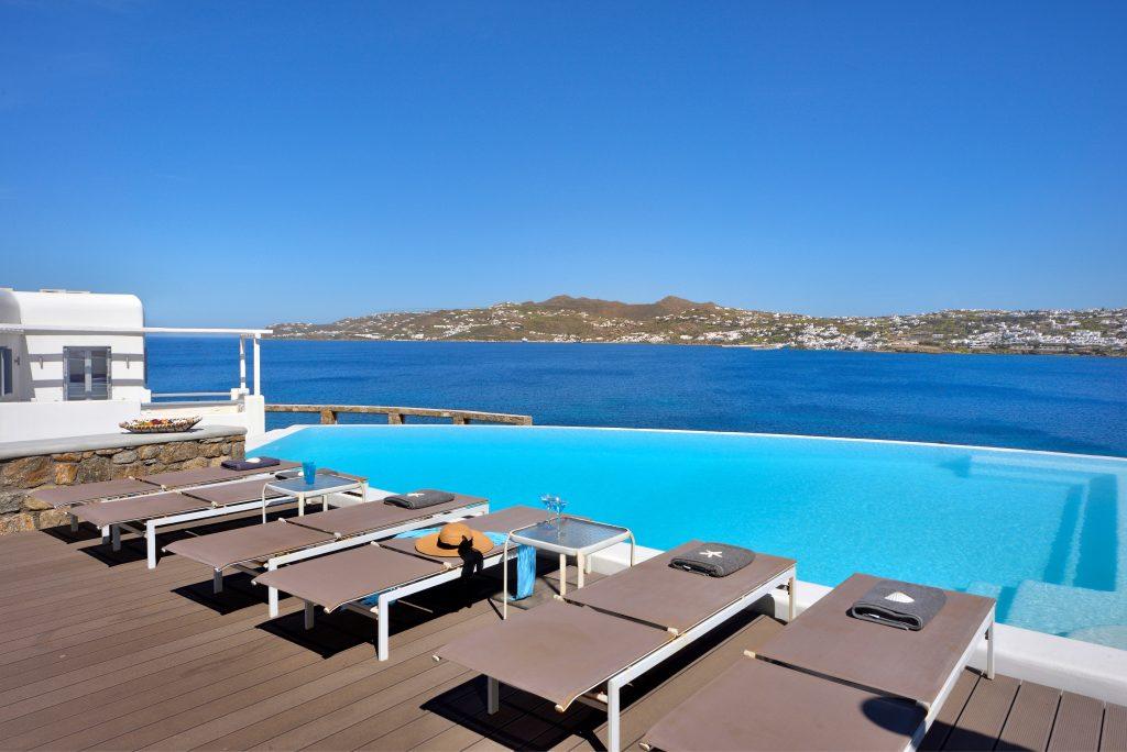 view of the bright blue sea and nature from the pool ideal for enjoyment