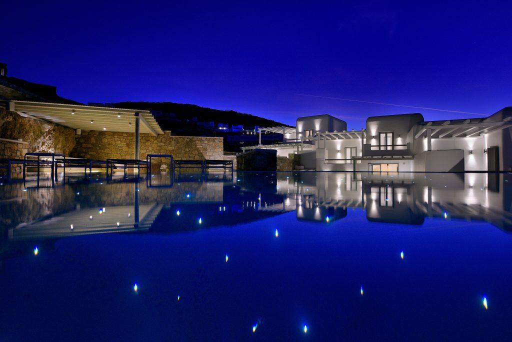 night view of a white luxury villa lit by lamps
