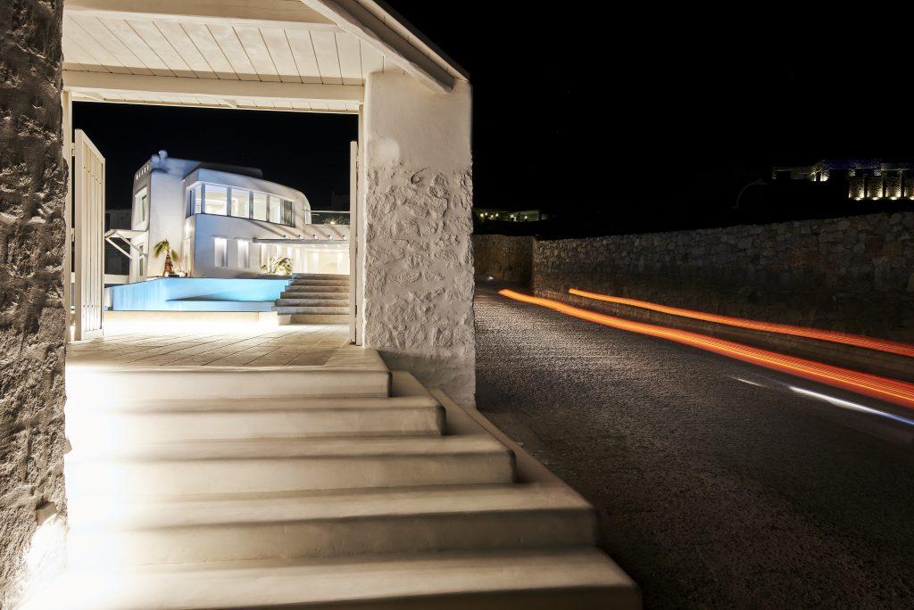 luxury villa with white steps at the entrance leading to the pool