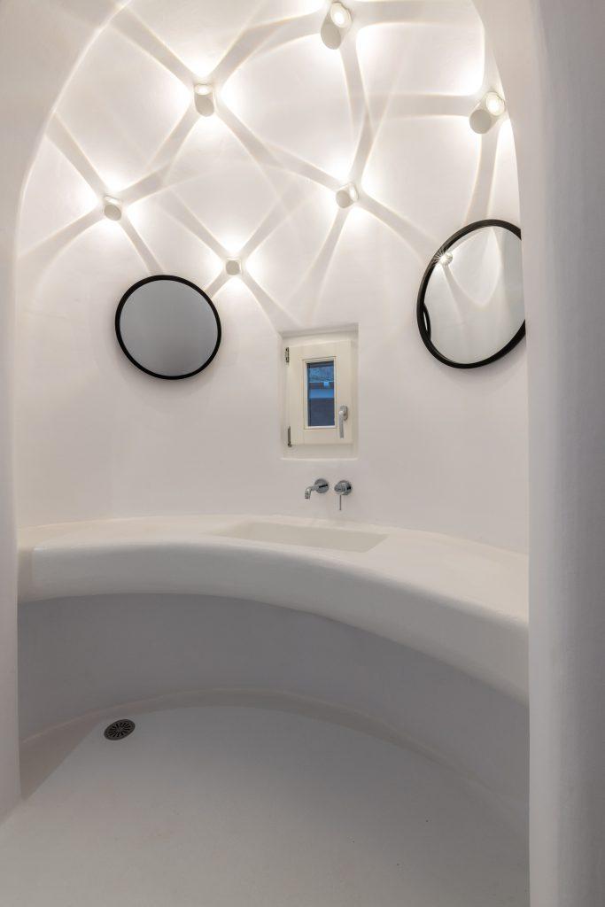 bathroom with white walls and decorative lighting