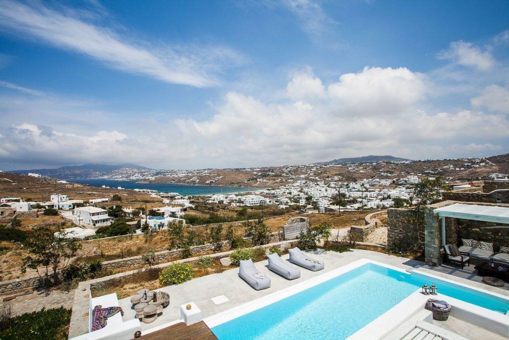 view of the sea and the city of Mykonos from the courtyard of a luxury villa