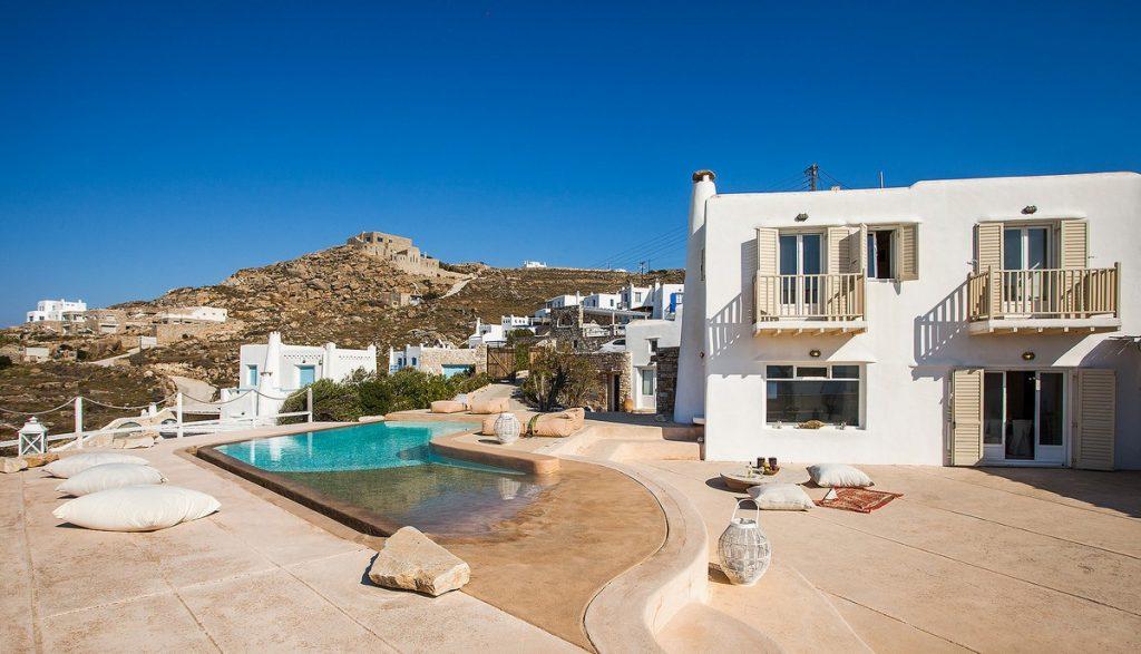 villa with a pool of pleasant water and large soft pillows ideal for sunbathing